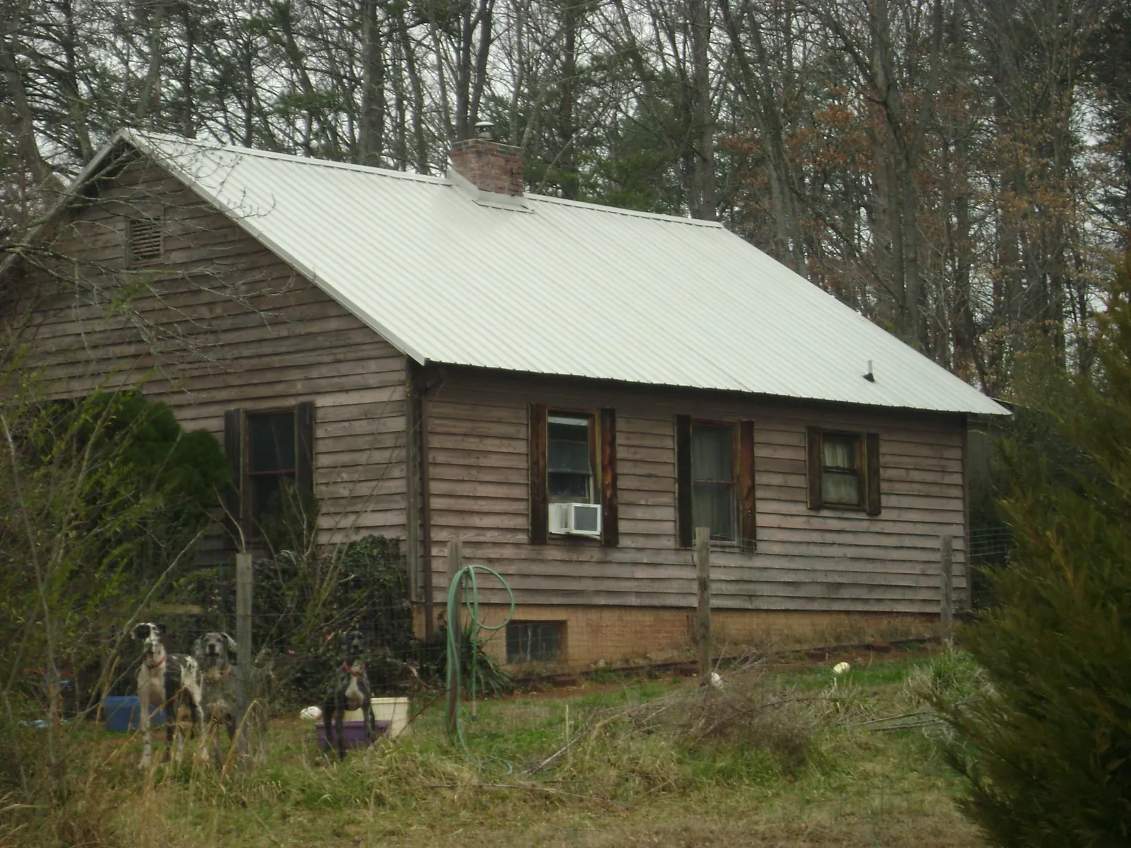 White metal roof on an old wood sided farmhouse, from a Metal Roof Installation job in Hampstead